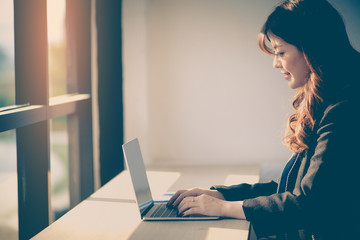 Business woman working at office desk and typing on a laptop. Business concept.