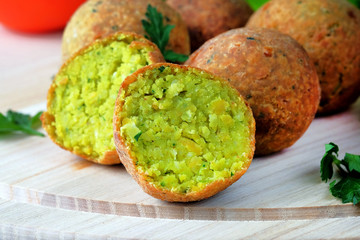 Falafel balls on a light cutting board. Vegetarian Middle Eastern food. Close-up view.