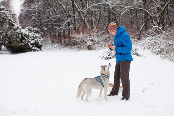 Man with husky dog at winter