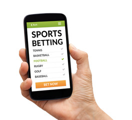 Hand holding a black smart phone with sports betting concept on screen. Isolated on white background. All screen content is designed by me.