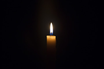 Candle flame closeup isolated on black. Abstract Background.