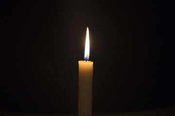 Candle flame closeup isolated on black. Abstract Background.