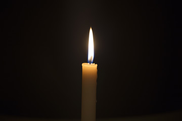 Candle flame closeup isolated on black. Abstract Background.