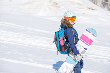 Fototapeta na wymiar Image of female athlete wearing helmet with backpack and snowboard