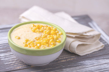 Polenta with feta. Corn porridge. Italian appetizers. Wooden background.