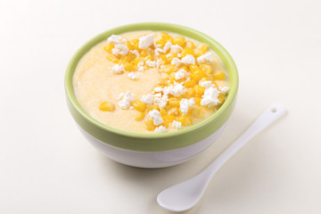 Polenta with feta. Corn porridge. Italian appetizers. Wooden background.