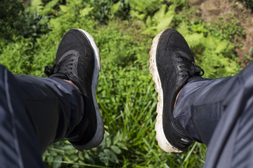 Feet of a tourist on the background of mountains