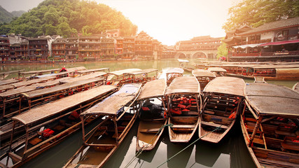China Fenghuang boat on the background of the old city