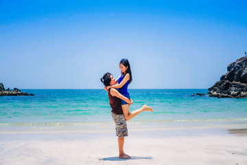 couple love on the beach.a man carrying a woman near the sea on vacation.tourist enjoying on holiday