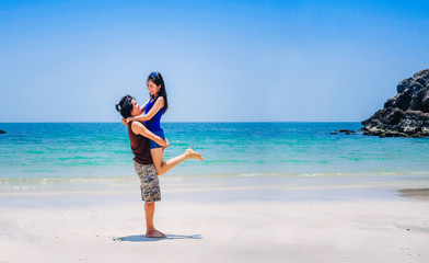 couple love on the beach.a man carrying a woman near the sea on vacation.tourist enjoying on holiday