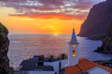 Naklejka premium Beautiful sunset over Camara de Lobos village and San Sebastian church on Madeira island, in Portugal