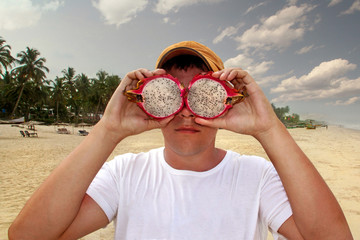 Man with a tropical fruit instead of binoculars