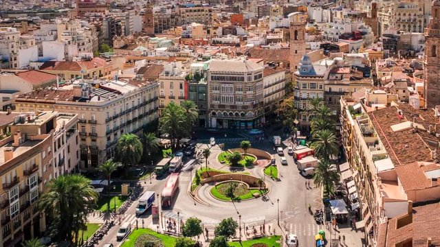 Valencia, Spain, time lapse view of traffic and people at Plaza de la Reina during daytime. Zoom out. 