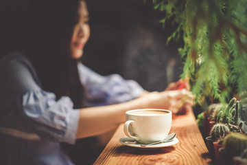 Asia woman reading a book and drinking a coffee in the coffee shop.Young lady on her lifestyle on holiday.