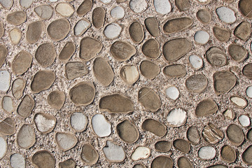 Texture - a fragment of a wall of rounded cobblestones