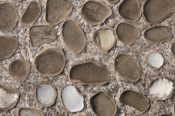 Texture - a fragment of a wall of rounded cobblestones