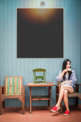 Asia woman sitting on the chair and drinking coffee at coffee shop during her vacation.beauty corner at coffee shop in vintage style. 