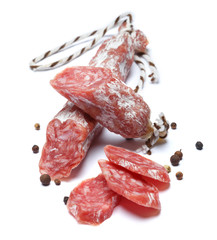 Dried organic salami sausage on white background