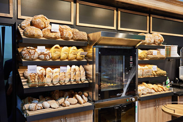 Fresh bread and pastries on shelves in bakery