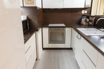 Modern kitchen in white and brown color design