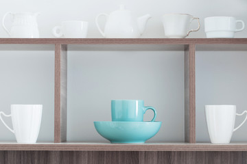 Obraz premium white kitchenware on wooden shelf