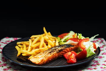 Grilled Salmon with fresh lettuce and Golden French fries