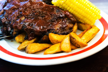 Grilled steak - Grilled meat ribs on the plate with hot sauce