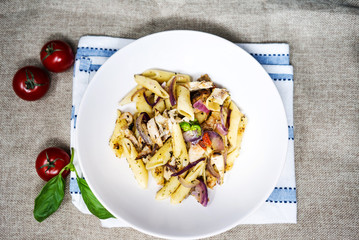 Pasta with pesto sauce and nuts on a the table
