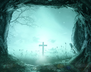 Good Friday concept: Empty tomb with cross on night background