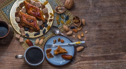 Baklava, coffee and nuts. Eastern still life. View from above.