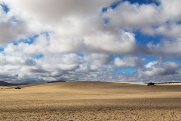 Sand against cloudy sky