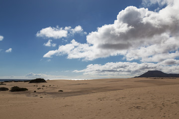 Sand against cloudy sky