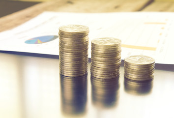 Close-up stack of money with paper document on background, warm theme from sunlight