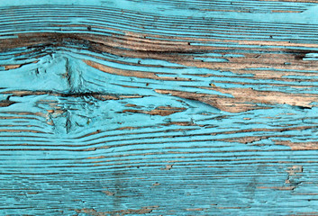 Naklejka premium Old wooden background with remains of pieces of scraps of old paint on wood. Texture of an old tree, board with paint, vintage background peeling paint. old blue board with cracked paint, vintage