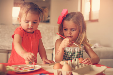 Fototapeta premium Kids Easter preparation by painting Easter eggs.