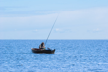 Fototapeta premium fisher in boat at Baikal