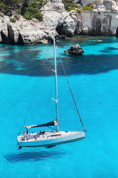 Fototapeta Beautiful bay in Mediterranean sea with sailing boat, Menorca island, Spain. Yachting, travel and active lifestyle concept