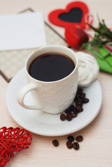 Worktable with Laptop, Cup of Coffee, Green Leaves. Heart shape, Love. Beige Neutral Background. Office concept. Flat Lay.