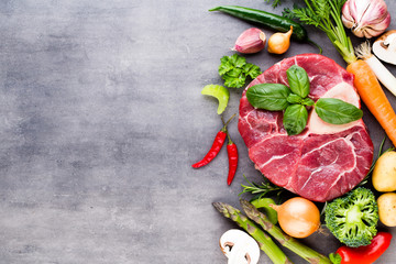 Raw fresh meat Ribeye Steak with vegetables and spice.