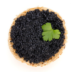 Canapes with black sturgeon caviar and  spice isolated on the white background.