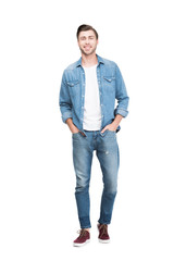 young smiling man in jeans looking at camera, isolated on white