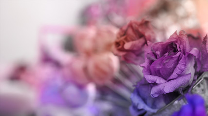 Blurred image, beautiful purple color flower bouquet with sun light and vintage color tone process for love romance background