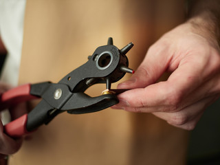 Puncture holes in the strap using a punch.