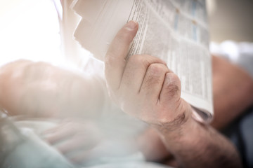 News paper in hand.