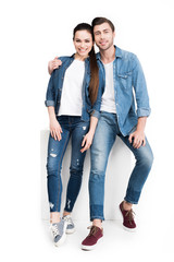 hugging smiling couple in jeans, isolated on white