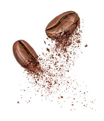 Two coffee beans broken into powder close-up on a white background