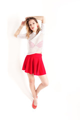 Isolated photo. The young girl with red lips and skirt on the white background