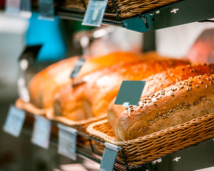 Fresh breads on shelf in bakery shop