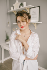 Beautiful young model with red lips and white man shirt