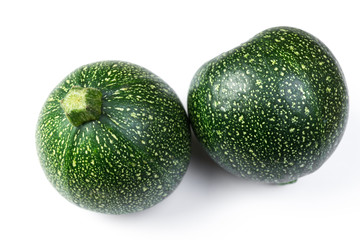 Two round zucchini on wooden background